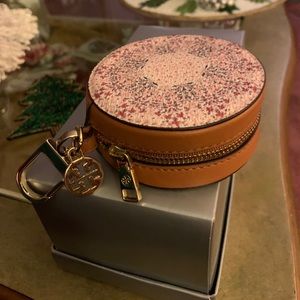 Tory Burch change purse with key ring.